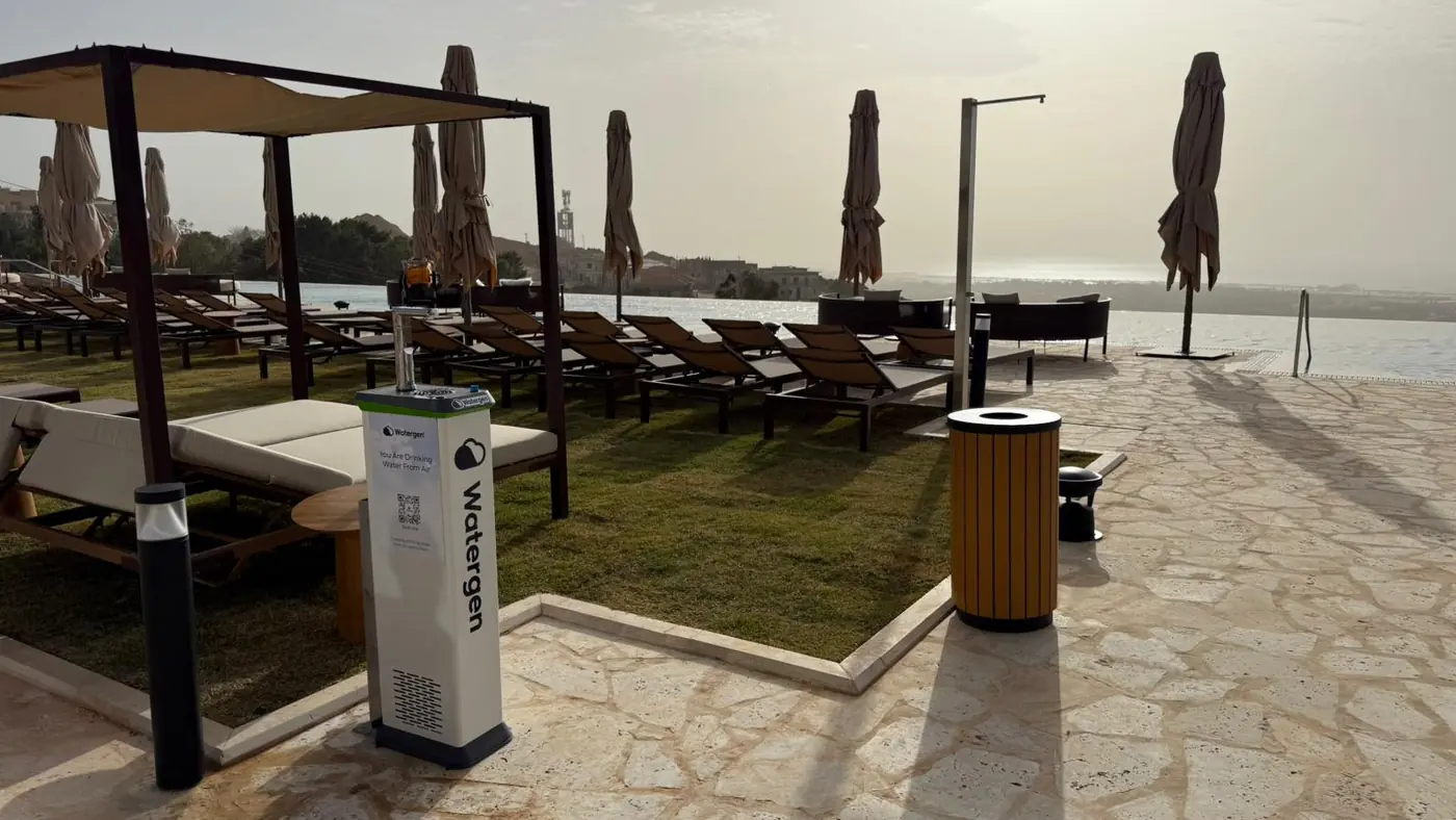 A Watergen dispenser beside the infinity pool at Gordonia, the sea beyond