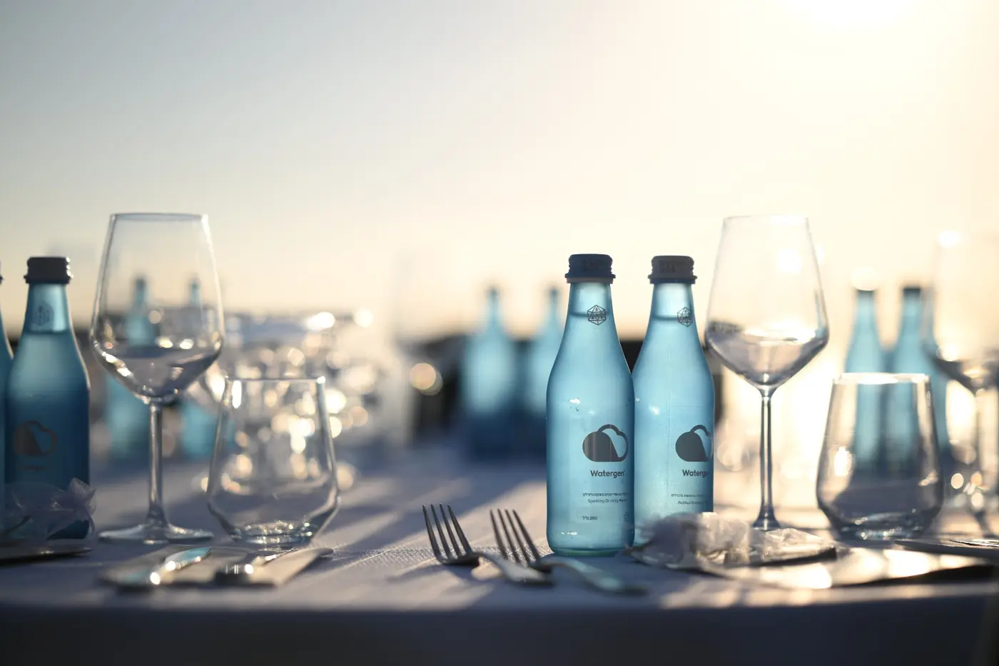 Watergen glass bottles on a laid dinner table at Gordonia