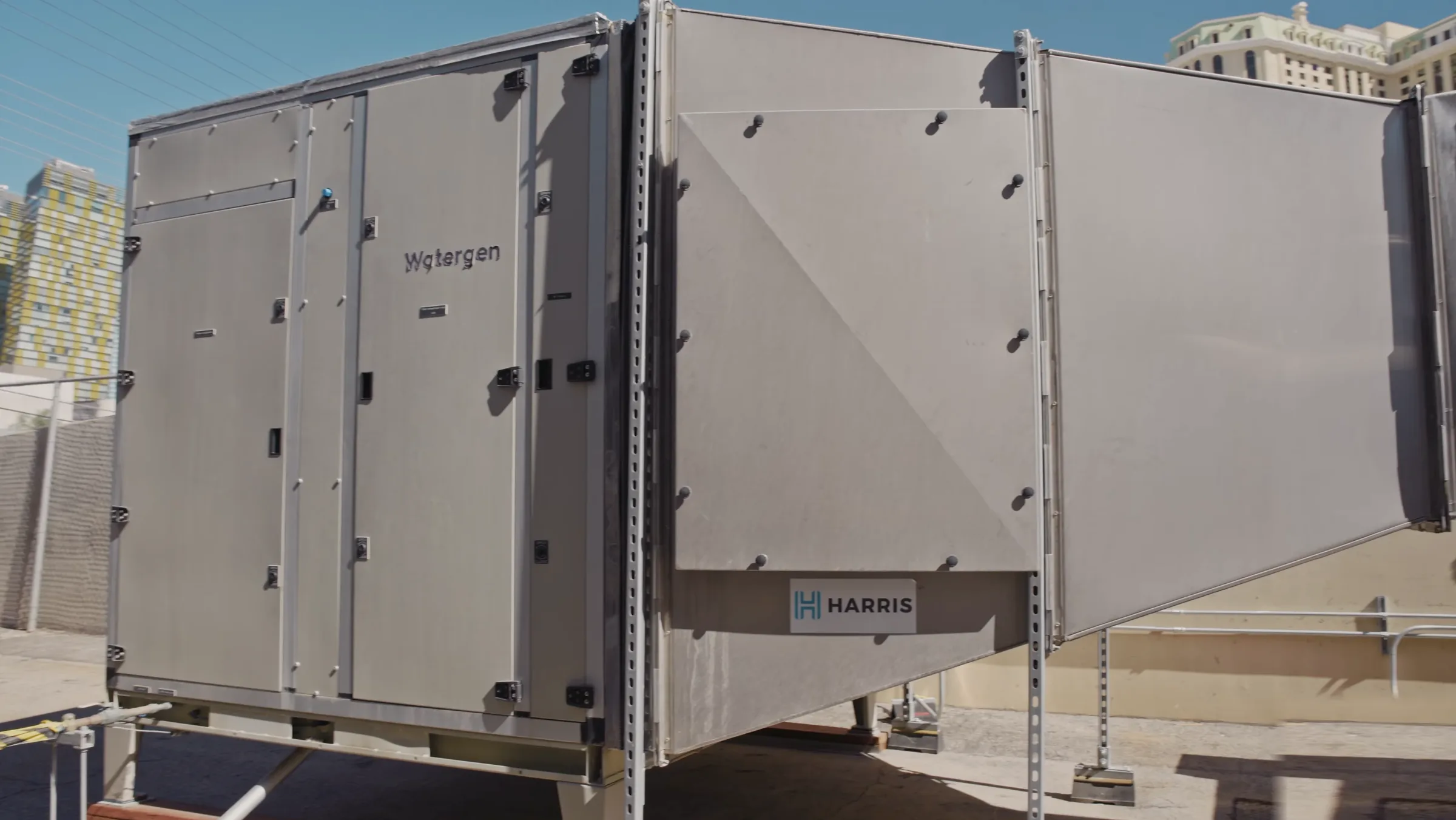 The Watergen atmospheric water generator installed at the MGM Grand, Las Vegas towers behind it
