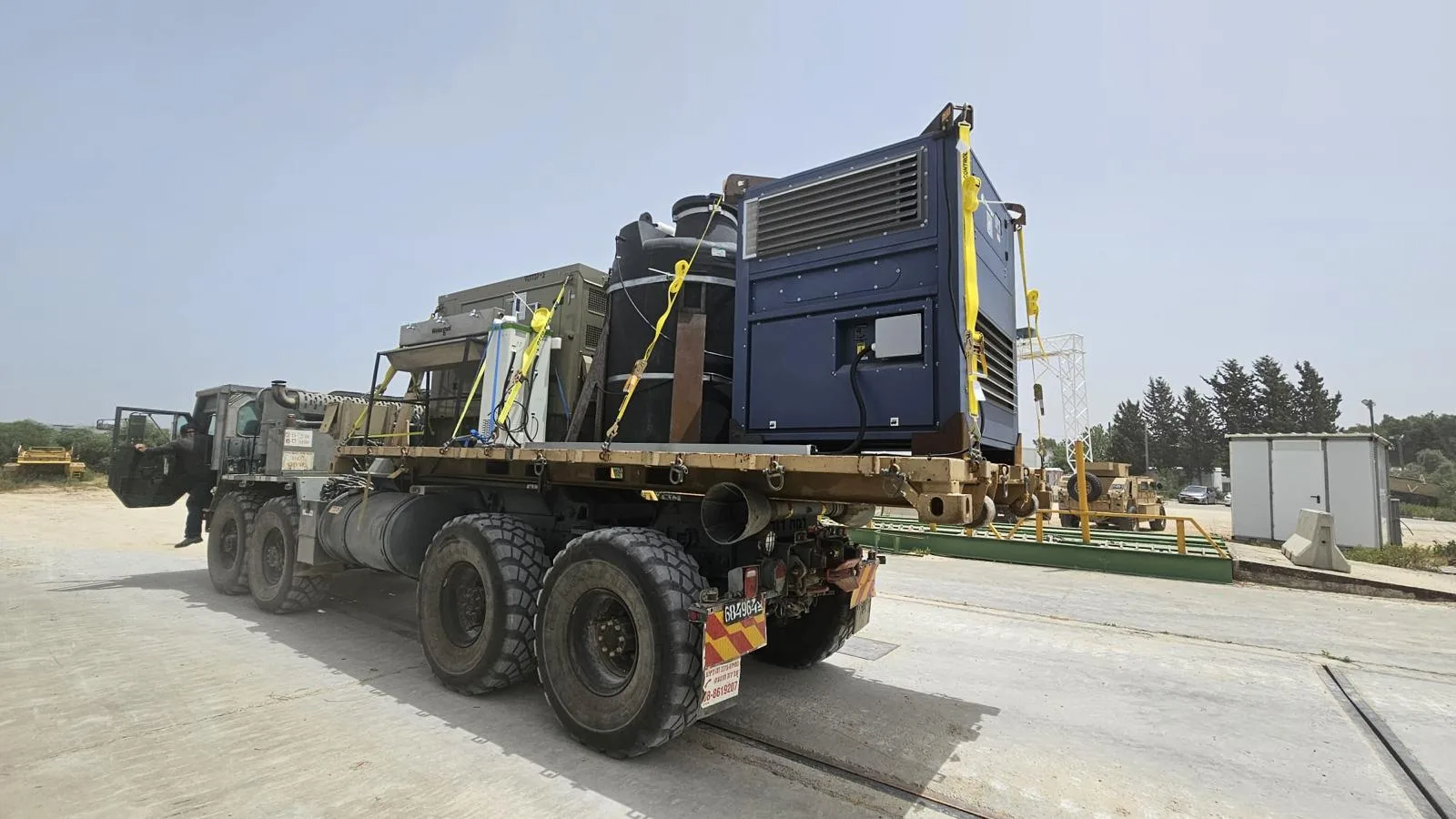 A Watergen generator, treatment unit and storage tanks strapped to a military truck
