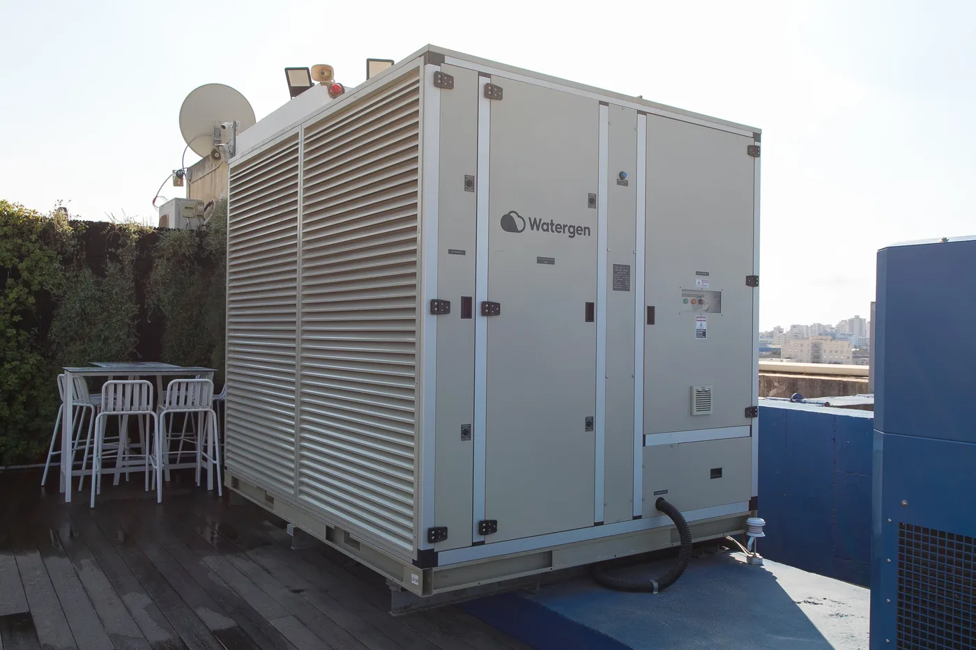 Watergen GEN-L unit producing water from air on a city rooftop