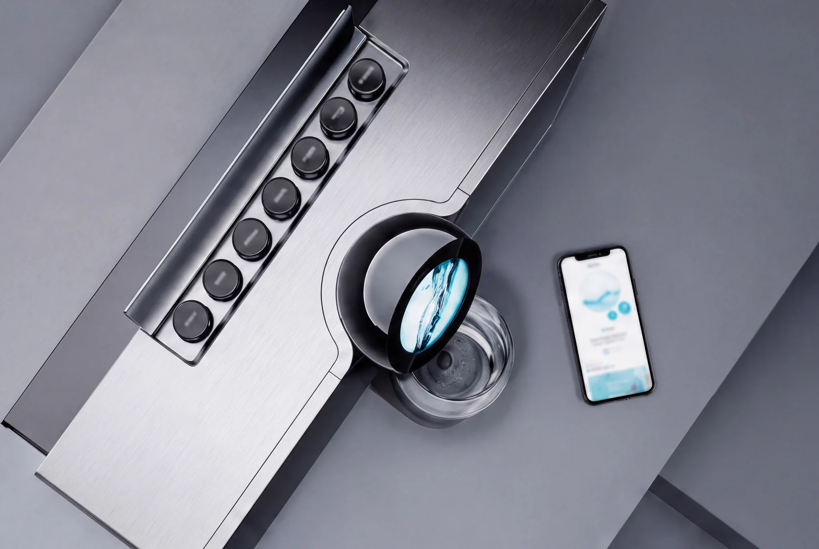 Watergen Countertop seen from above — the row of controls, a glass filling under the spout and the companion app